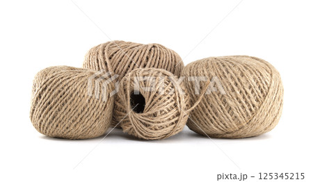 Closeup of four textured twine balls, creating a natural and rustic display against a white backdrop Closeup of four textured twine balls, creating a natural and rustic display against a white backdrop 125345215