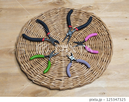 Various wire cutters are laid out on a table 125347325