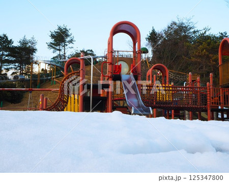 雪の積もった公園の滑り台 125347800