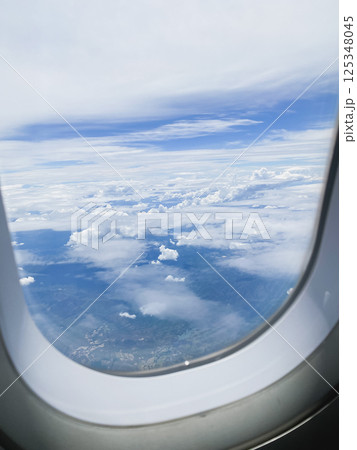 travel and transportation concept with see city and beautiful sky from airplane window travel and transportation concept with see city and beautiful sky from airplane window 125348045
