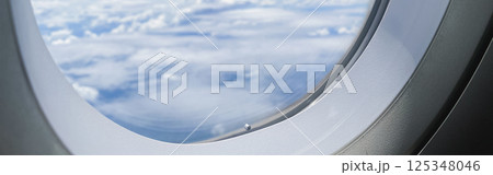 travel and transportation concept with see city and beautiful sky from airplane window travel and transportation concept with see city and beautiful sky from airplane window 125348046