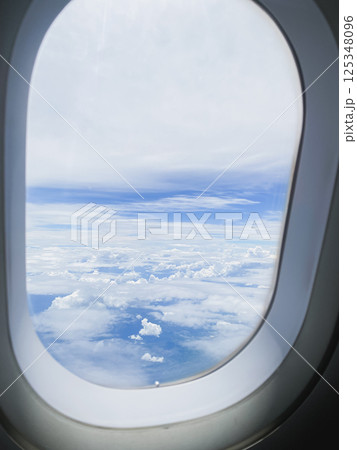 travel and transportation concept with see city and beautiful sky from airplane window travel and transportation concept with see city and beautiful sky from airplane window 125348096