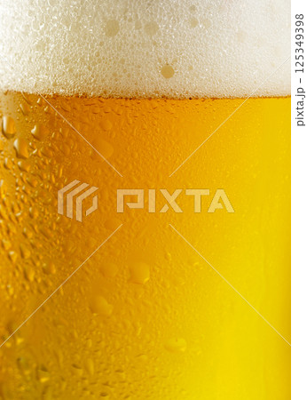 glass of beer with bubble and froth as background glass of beer with bubble and froth as background 125349398