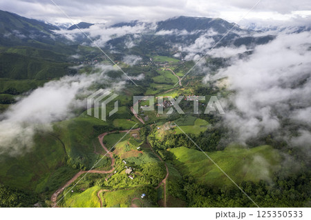 Landscape of Morning Mist with Mountain Layer. mountain ridge and clouds in rural jungle bush forest 125350533