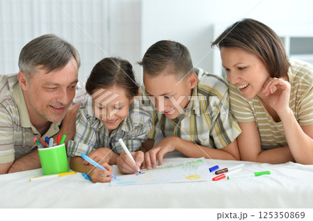 Family Drawing Together on the Floor 125350869