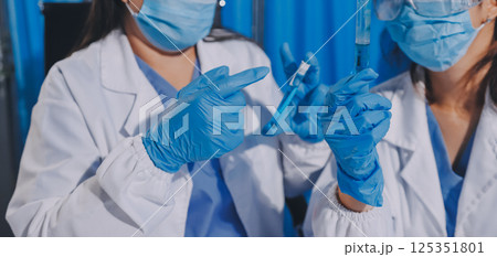 Researcher using a professional microscope Researcher using a professional microscope 125351801