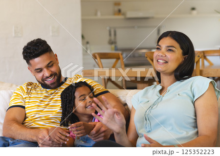 Happy family relaxing on sofa at home, enjoying quality time together Happy family relaxing on sofa at home, enjoying quality time together 125352223