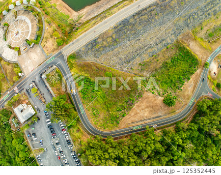 Aerial view Curve road top view rainforest trees summer background Aerial view Curve road top view rainforest trees summer background 125352445