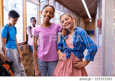 Smiling girls standing in school hallway, enjoying time with friends Smiling girls standing in school hallway, enjoying time with friends 125353365