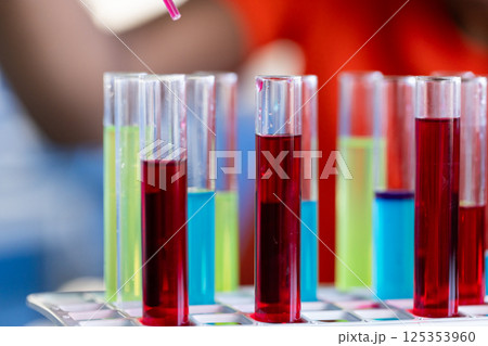 Using pipette with colorful liquids, student conducting science experiment at school, copy space Using pipette with colorful liquids, student conducting science experiment at school, copy space 125353960