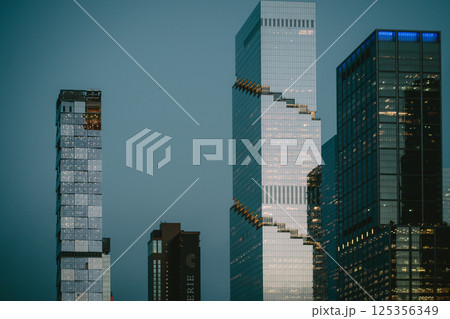 A collection of tall buildings featuring stairs that connect them all 125356349