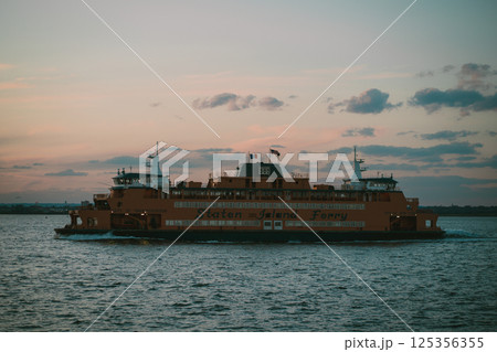 A ferry boat is currently floating peacefully on top of a body of water 125356355