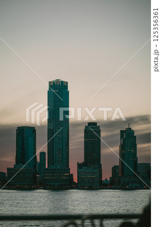 A picturesque city skyline featuring a breathtaking sunset in the background A picturesque city skyline featuring a breathtaking sunset in the background 125356361