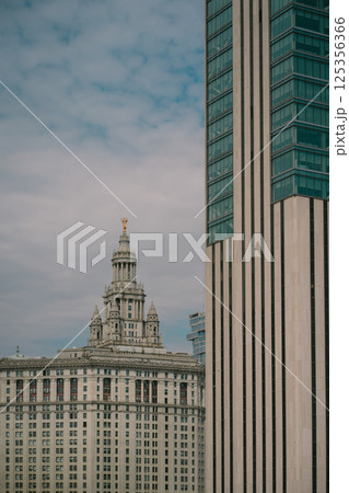 A tall domed building is surrounded by other tall buildings 125356366
