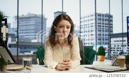 Female CEO meeting with shareholders on a videocall to discuss investment plans, being determined to expand the business internationally. Powerful ambitious woman director shares ideas. Camera B. Female CEO meeting with shareholders on a videocall to discuss investment plans, being determined to expand the business internationally. Powerful ambitious woman director shares ideas. Camera B. 125356532