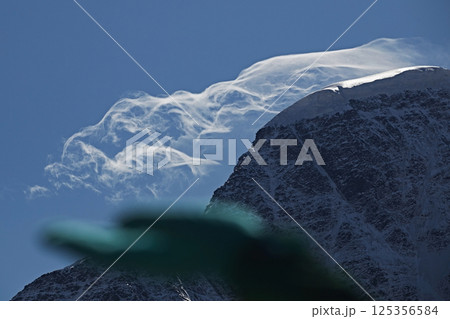 Human hand holding cloud in mountains close up 125356584