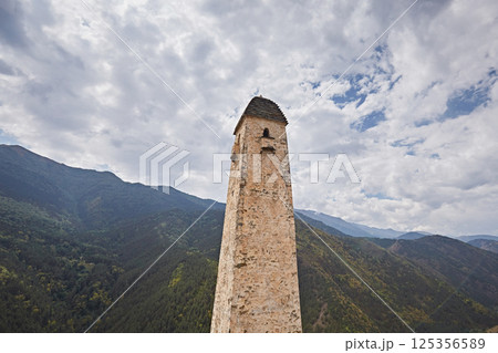 High stone tower in Caucasus, medieval castle against sky, close-up High stone tower in Caucasus, medieval castle against sky, close-up 125356589