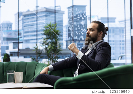 Goal oriented businessman focuses on his company and career development, analyzing reports and trends to ensure a success story in the competitive environment of business industry. 125356949