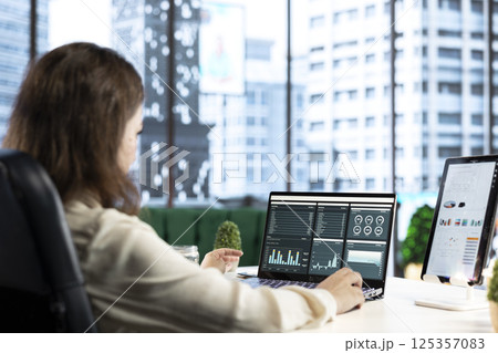 Forecast expert CEO analyzing investment insights and negotiations details, looking at data analytics and reports to establish the corporation vision and objectives. Business productivity. 125357083