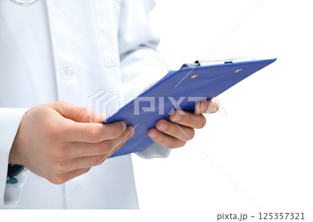 On World Doctor's Day, a doctor preps for patient care with professional focus, isolated on white, PNG On World Doctor's Day, a doctor preps for patient care with professional focus, isolated on white, PNG 125357321