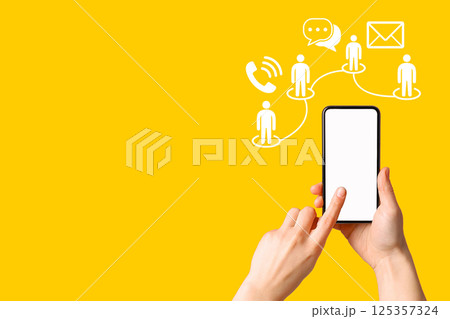 Hand holds a smartphone showing different communication methods on a bright backdrop 125357324