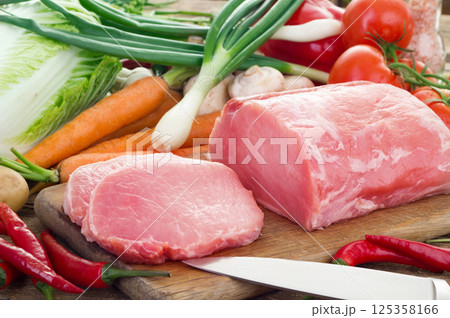 Vegetables and pork meat on cutting board 125358166
