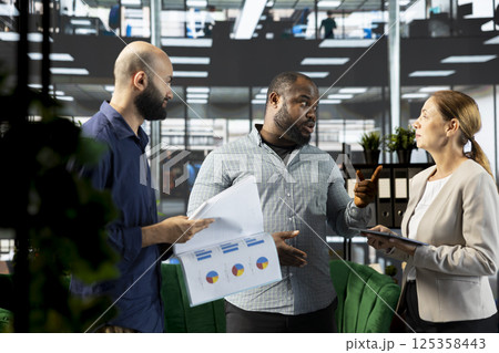 Upset manager berating employees, unsatisfied with progress done on customer commissioned project after reading company documents. Mad supervisor scolding workers, displeased by business audit results Upset manager berating employees, unsatisfied with progress done on customer commissioned project after reading company documents. Mad supervisor scolding workers, displeased by business audit results 125358443