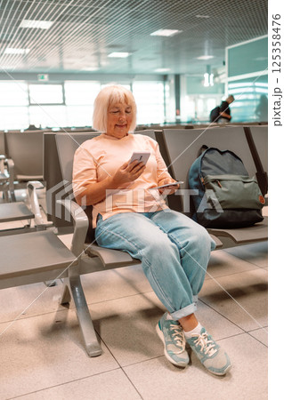 Qr code, check in and man with a phone for a ticket, airplane booking and information at airport. Travel, website and hand of a businessman reading a barcode on a mobile for a work trip or vacation 125358476