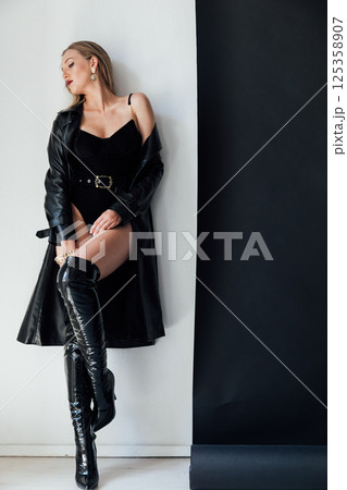 Fashionable slim woman in black clothes and makeup Fashionable slim woman in black clothes and makeup 125358907