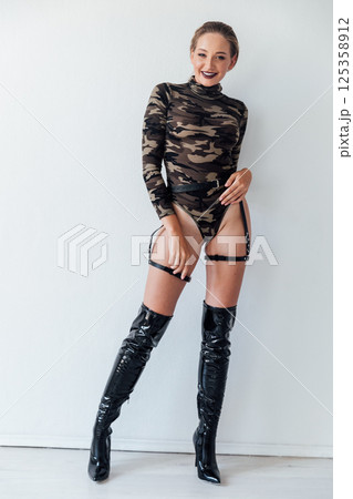 Slim military woman in black boots 125358912