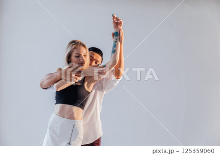 Man and woman dancing together to salsa Man and woman dancing together to salsa 125359060