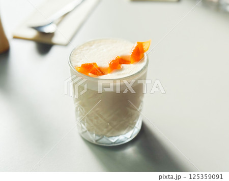 Refreshing citrus cocktail on a white table. Handcrafted beverages and stylish cafe culture concept 125359091