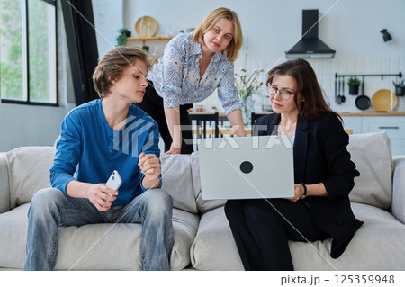 Family, mother and teenage son meeting with social worker sitting on couch at home Family, mother and teenage son meeting with social worker sitting on couch at home 125359948