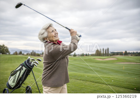A senior woman playing golf with happy emotions 125360219