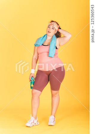 A woman in a pink tank top A woman in a pink tank top 125360543