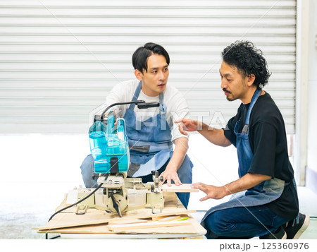 電動ノコギリを使い方を教わる男性　DIY 125360976