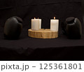 three burning candles on the oak stand  in the dark on the eve of the Christian Easter holiday in spring 125361801