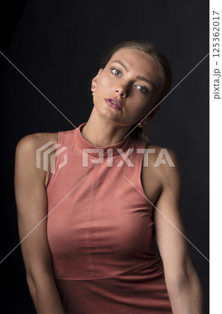 portrait of a young beautiful woman on a dark background portrait of a young beautiful woman on a dark background 125362017
