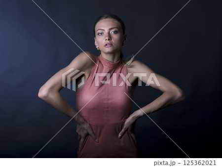 portrait of a young beautiful woman on a dark background 125362021
