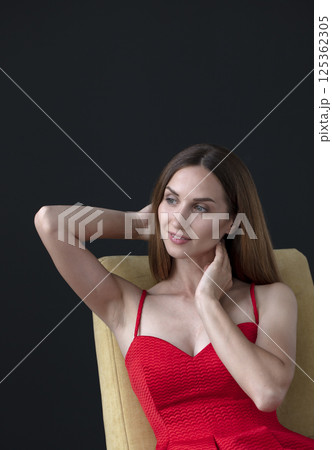 studio portrait on a dark background of a beautiful young woman 125362305