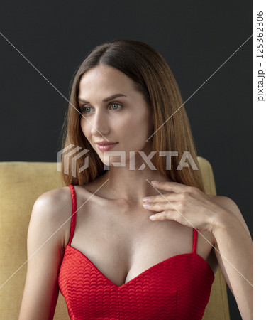 studio portrait on a dark background of a beautiful young woman 125362306
