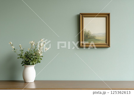 White vase with flowers sits on a wooden table 125362613