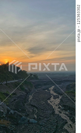 Sunrise on the eastern horizon over the Semeru lava trail 125363302