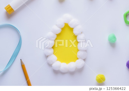 Step by step instruction. Making of handmade Easter egg from pompons. DIY Kids Craft concept. Step by step 2 Step by step instruction. Making of handmade Easter egg from pompons. DIY Kids Craft concept. Step by step 2 125366422