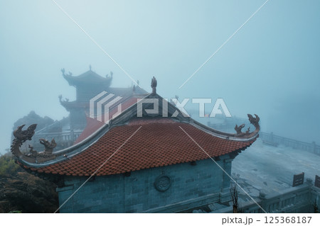 Temple foggy in mysterious mountain at Fansipan, Vietnam Temple foggy in mysterious mountain at Fansipan, Vietnam 125368187