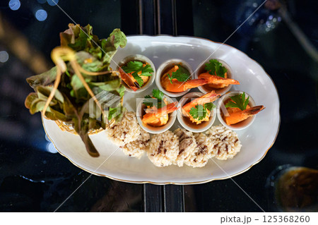Gourmet seafood spicy shrimp, crispy rice, vegetable serving on table Gourmet seafood spicy shrimp, crispy rice, vegetable serving on table 125368260