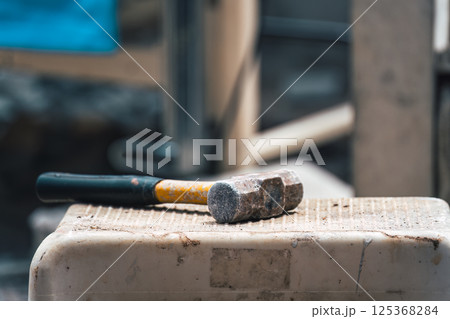 Hammer put on workbench in construction site Hammer put on workbench in construction site 125368284