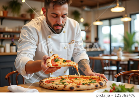 A man is holding a slice of pizza with a beard 125368476