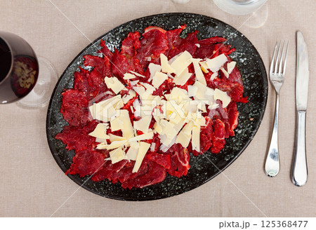 Raw beef meat, carpaccio, served on plate 125368477