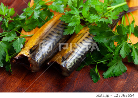 Tasty hot smoked mackerel with greens on wooden surface Tasty hot smoked mackerel with greens on wooden surface 125368654